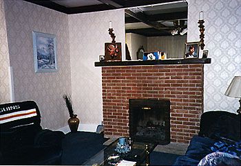 Newer walls on built on either side of the fireplace hid boarded windows. The original art glass, and built-in bookcases, had been removed and discarded.