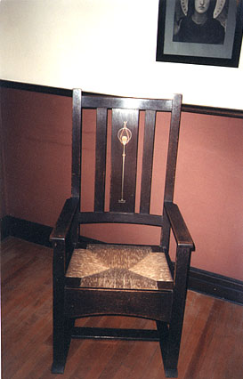 A Stickley arm chair, with copper and pewter inlay, designed by Harvey Ellis. Part of a collection of five Ellis/Stickley pieces.