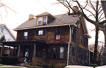 Stone and shingle foursquare with offset porch (1910)